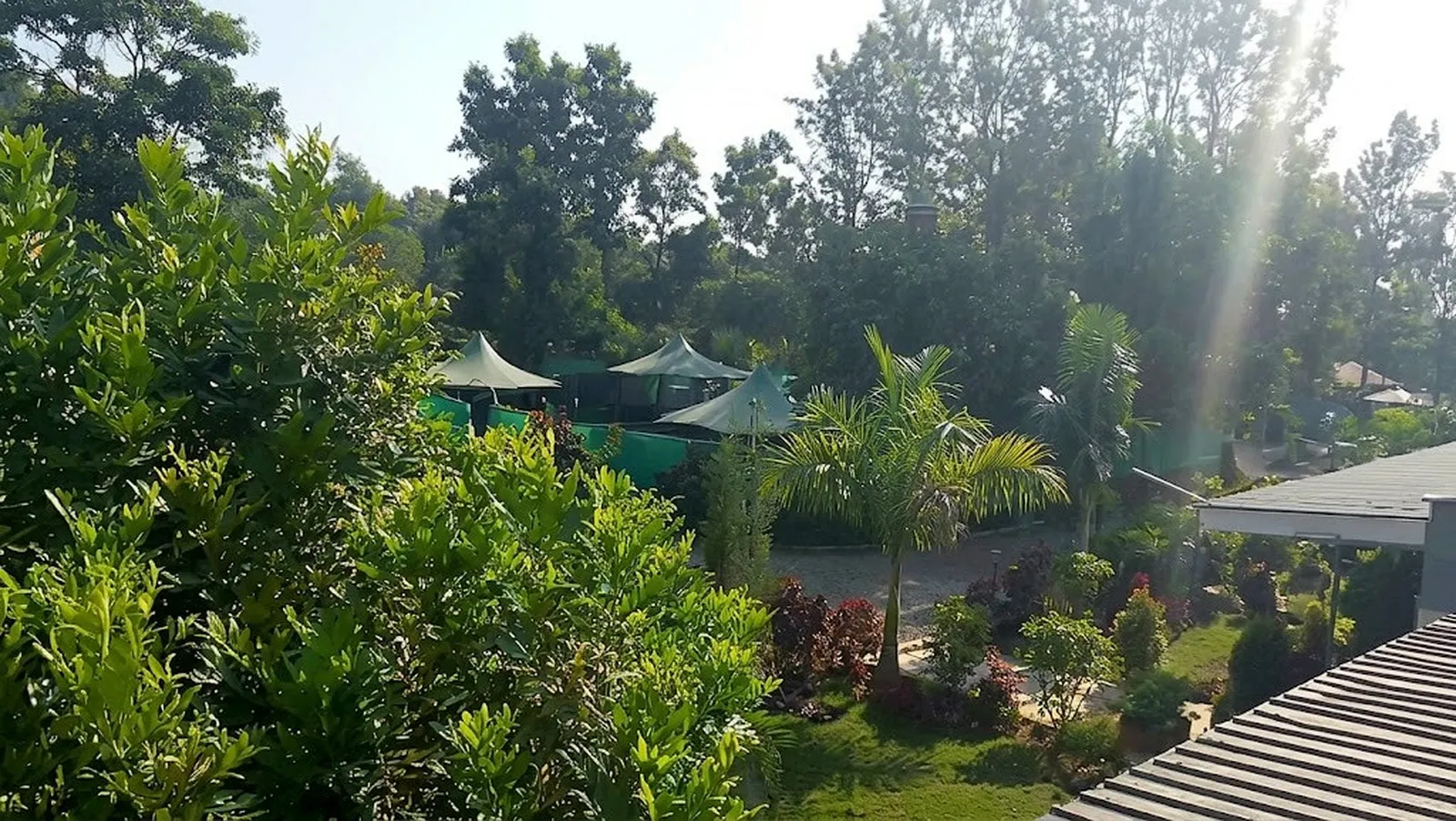 View from above of the gardens, gazebos and trees at LeGladje Resort