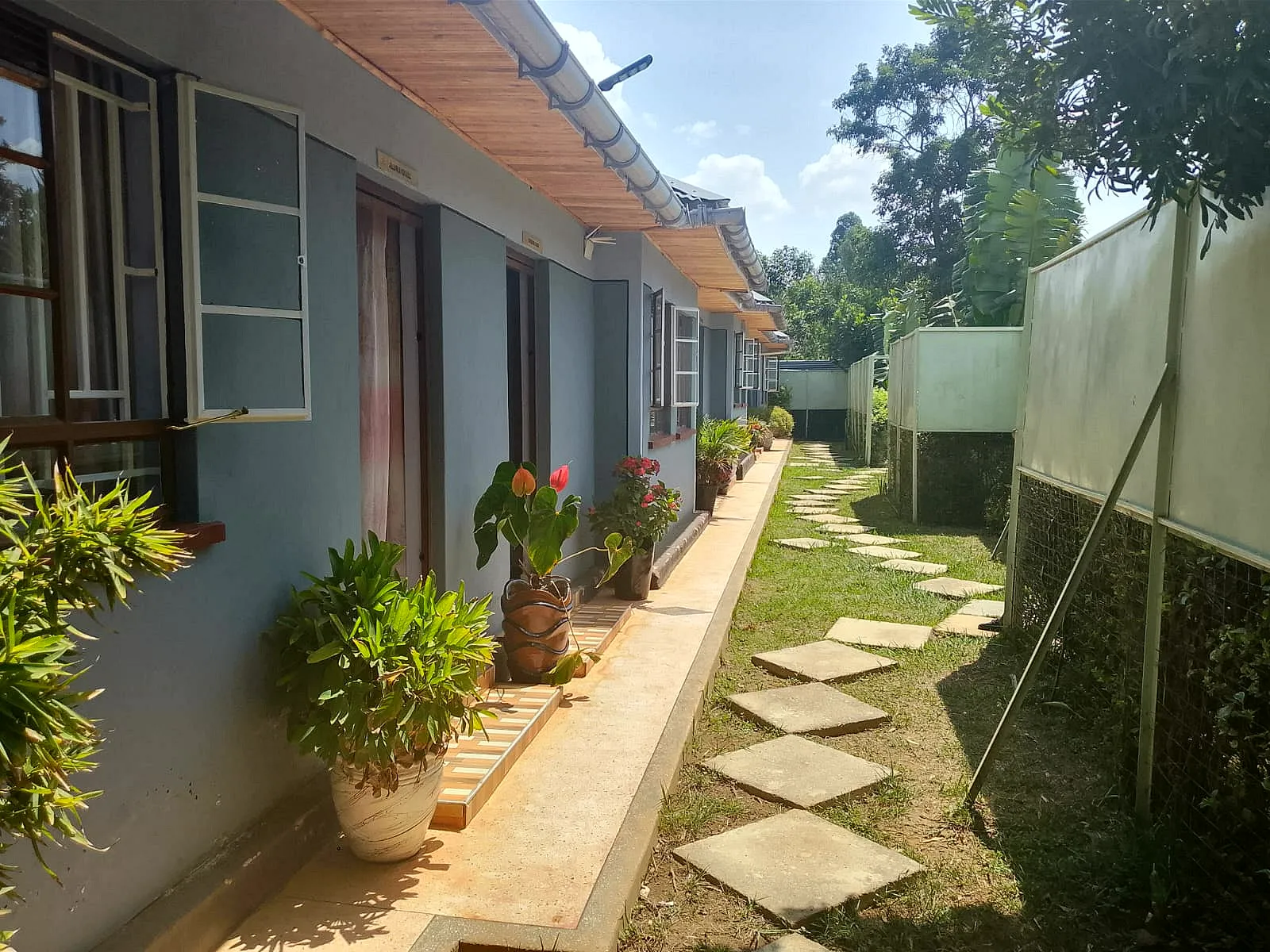 Guest room doors along the garden walkway at LeGladje Resort